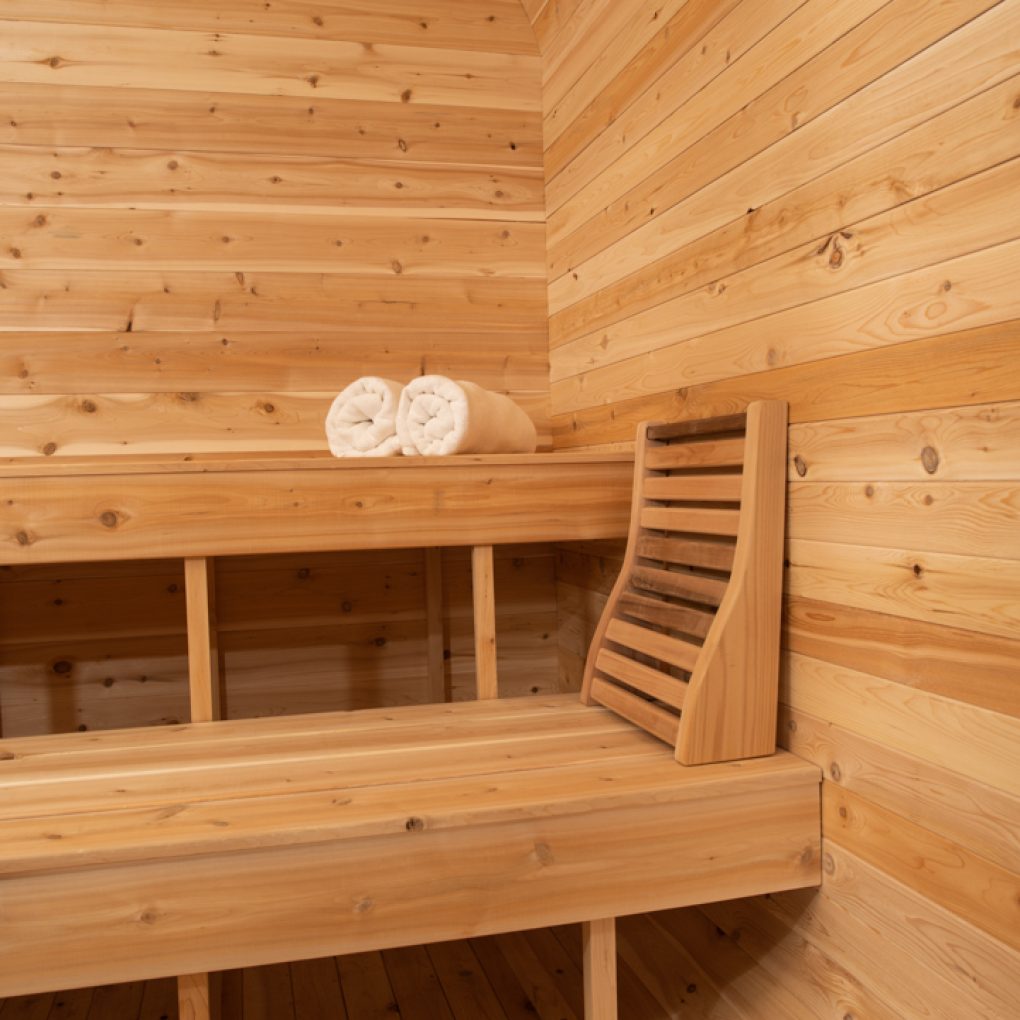 A luxurious sauna room made of Dundalk Canadian Timber Luna 2 to 3 Person White Cedar featuring towels scattered on the floor.