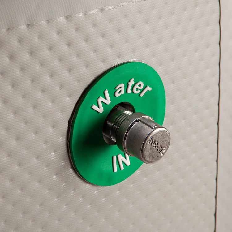 A Cryospring portable green button with the word water in it.