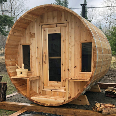 A Dundalk Canadian Timber Tranquility Sauna manufactured by Dundalk Leisurecraft sitting on a wooden deck.
