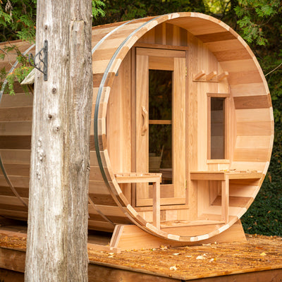 A Dundalk Leisurecraft Cedar Barrel Sauna made with Dundalk Canadian Timber Tranquility Sauna.