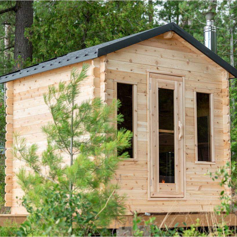 A luxurious Dundalk LeisureCraft Eastern White Cedar log cabin nestled in the backyard, providing a tranquil recovery space.