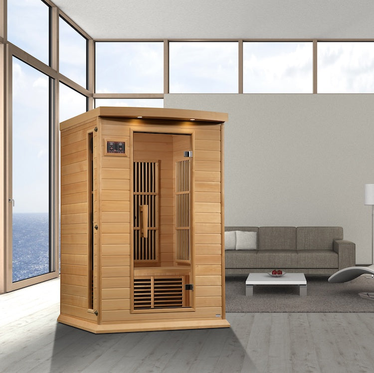 A Maxxus Saunas 2-Person Near Zero EMF FAR Infrared Sauna (Canadian Hemlock) in a living room, emitting Near Zero EMF for a comfortable and relaxing experience.