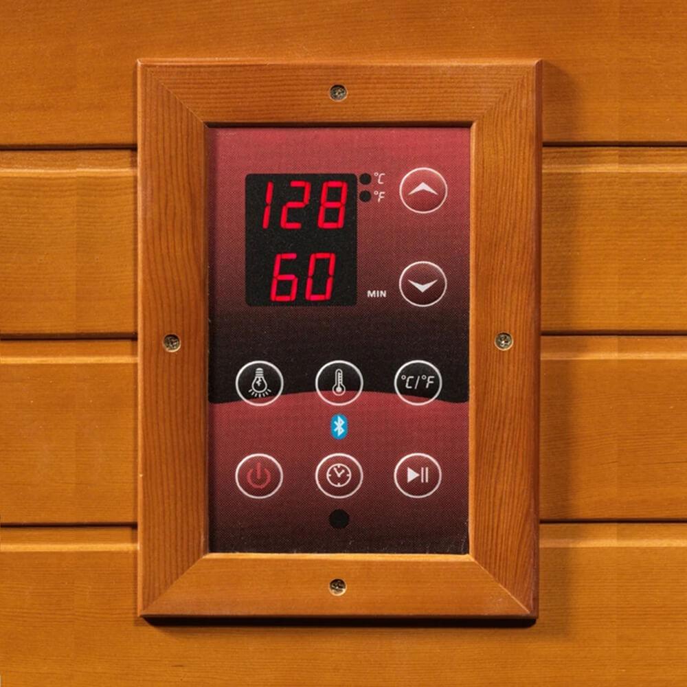 A Dynamic Saunas' Dynamic Venice 2-Person Low EMF Far Infrared Sauna DYN-6210-01 with a clock on the wall, providing a soothing and rejuvenating experience. Experience the health benefits of Dynamic Saunas' far infrared saunas while keeping track of