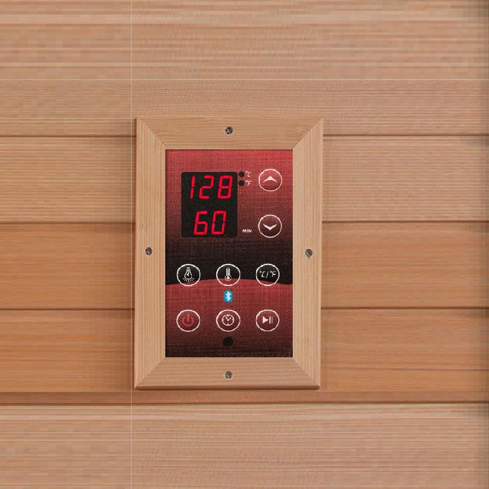 A Dynamic Saunas Low EMF FAR Infrared Sauna made with Canadian Hemlock Wood, featuring a clock on the wall.