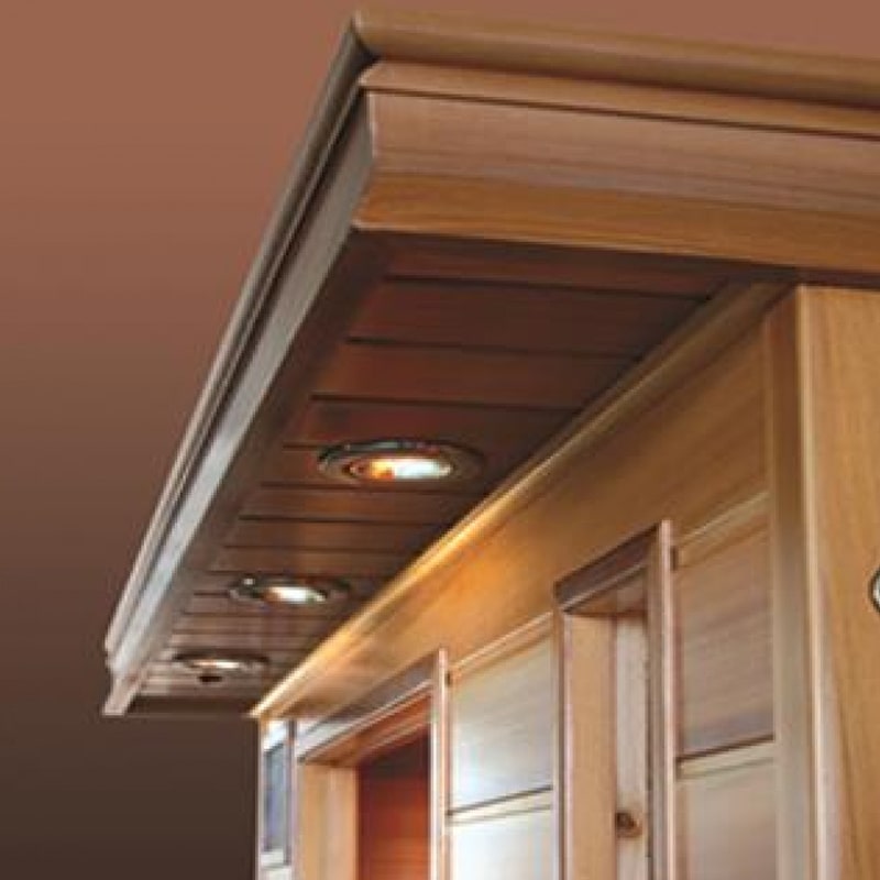 The SunRay Saunas infrared sauna utilizes carbon-nano heaters, specifically the SunRay Barrett 1 Person Infrared Sauna HL100K2, and features a wooden ceiling.